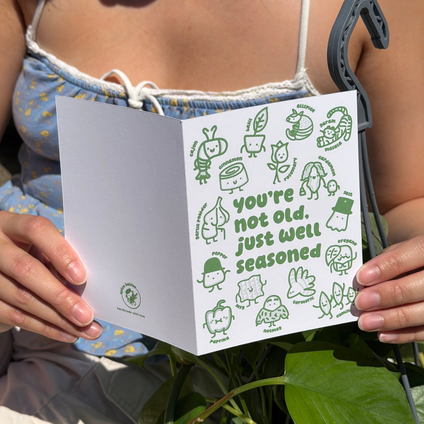 Person holding a birthday card saying youre not old, just well seasoned.