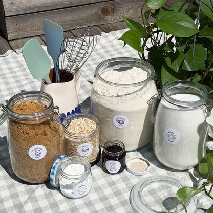 jars filled with baking ingredients with spice babies labels